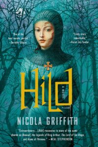 A girl wearing a blue head covering stands in front of trees and a blue background. HILD by Nicola Griffith