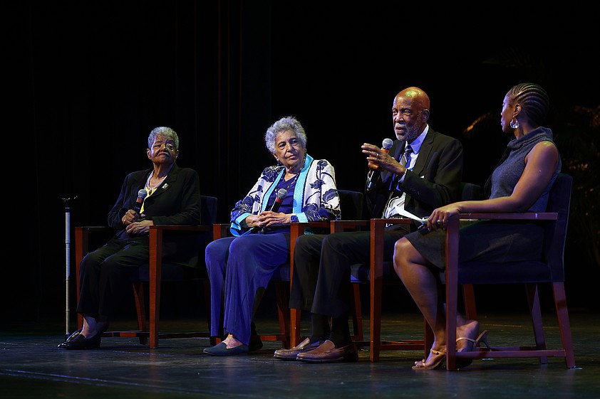 Dr. Terrence Roberts and other members of the Little Rock 9 sit on a stage